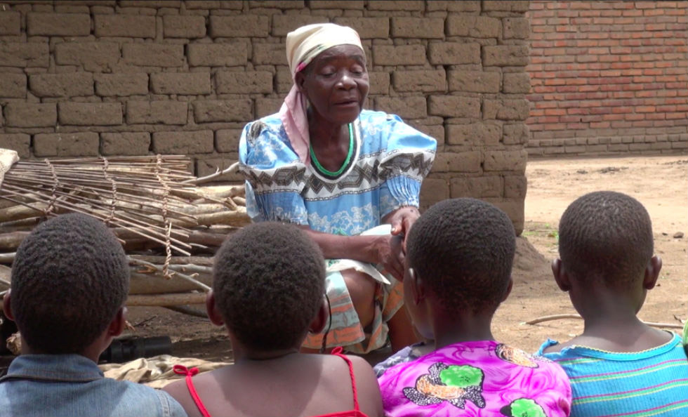 Full Image A female storyteller tells a folktale to an audience of children