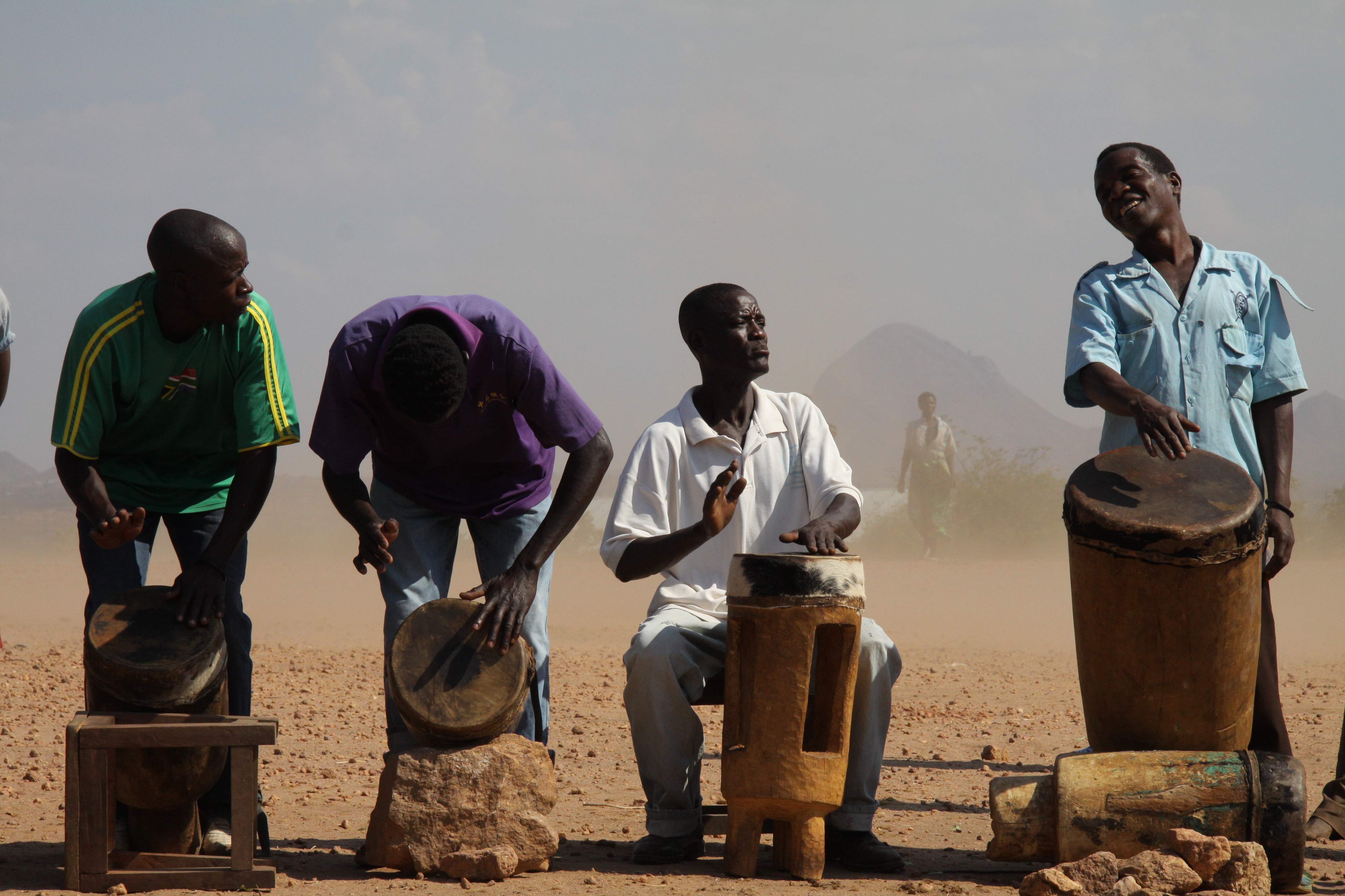 Full Image Four Malawian drummers participate in a drumming performance